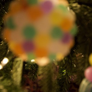 Colorful Christmas Ornament Through Evergreen Branches