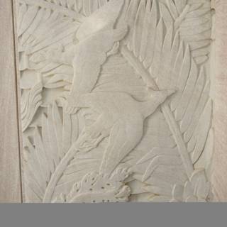 Intricate Carving of a Bird and Palm Leaves