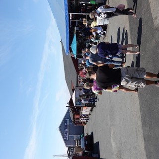 Busy Waterfront Market Scene with Crowds