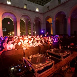 DJ Georgie Farmer performing for a crowded urban club