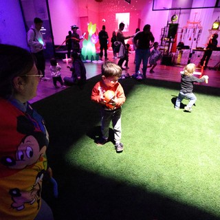 Children Dancing Under Colorful Lights at Baby Rave Event