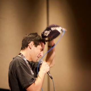 Mic in Hand, Hat on Head