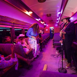 Intimate Live Music Performance on Purple-Lit Train Car