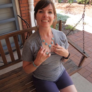 Woman Showing Off Turquoise Jewelry on Porch Swing