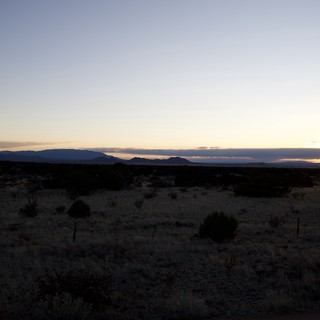 Desert Sunset Over Distant Mountain Range