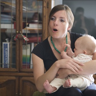 Young Mother Singing to Her Infant at Home