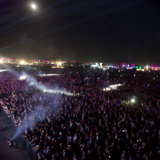 A sea of music lovers under the night sky