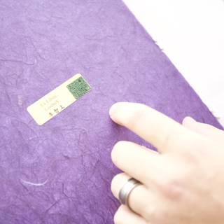 Purple Notebook with a Green Sticker
