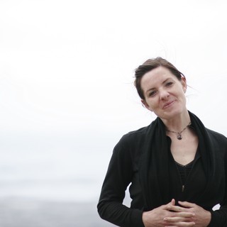 Windswept Woman Smiling by the Bay