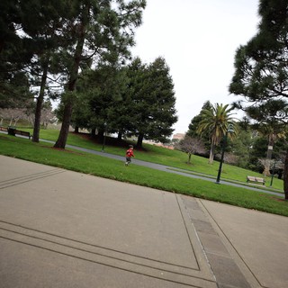 Child Running Through Park on Overcast Day