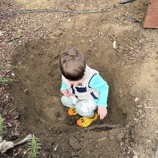 Young Child Playing in Garden Dirt Patch