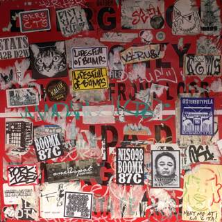 Sticker Collage Adorning a Red Wall