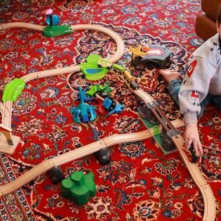 Young Boy Playing with Wooden Train Set on Christmas