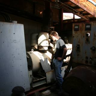 Man standing next to a large industrial generator