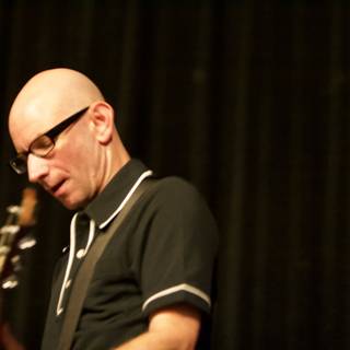Bald man rocks out on guitar at Bad Religion concert