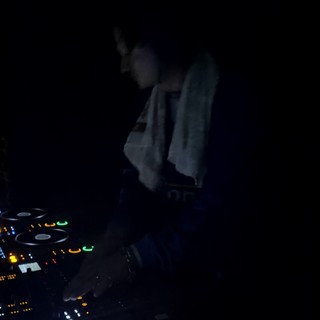 DJ Behind the Decks at Night Club Performance