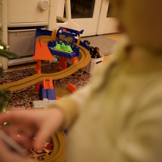 Child Playing with Toy Race Track at Home