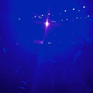 Blue Spotlights Shining on the Nightclub Crowd
