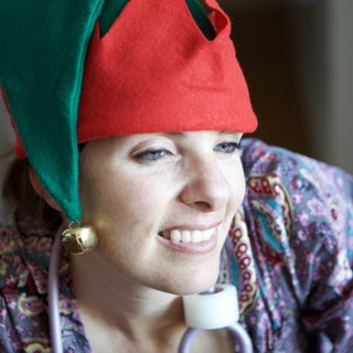 Joyful Woman in Christmas Elf Hat Smiling Warmly