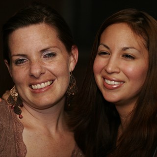 Two Women Smiling at a Night Event