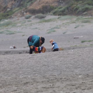 Family Beach Moment with Dog in Rainbow Sweater