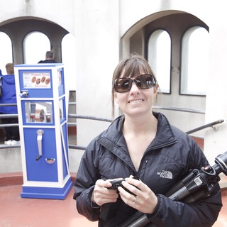 Photographer Smiling at Pressed Penny Souvenir Machine
