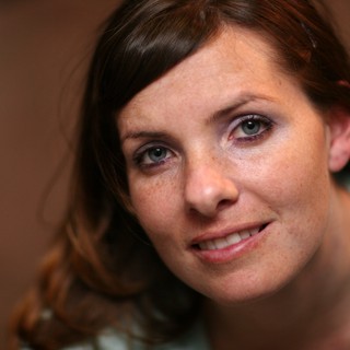 Freckled Woman with Blue Eyes Smiling Warmly