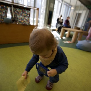 Toddler Exploring Play Space in Bright Indoor Environment