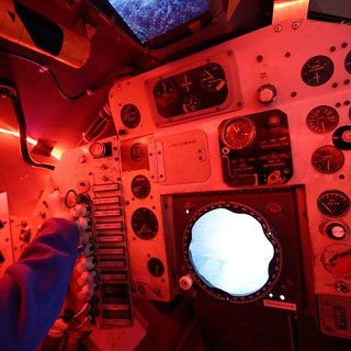 Inside a Vintage Spacecraft Control Module Under Red Lighting