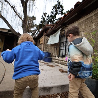 Two Young Boys Exploring a Historic Adobe Courtyard