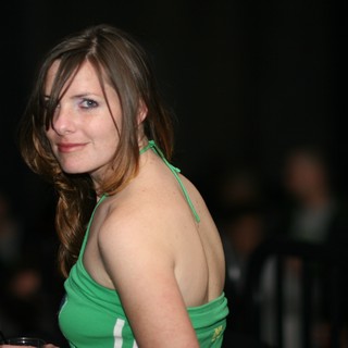 Woman in Green Halter Top at Evening Event