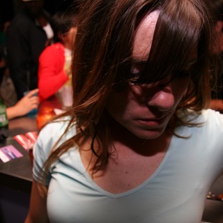 Young Woman Lost in Thought at Nightclub Bar