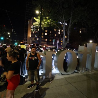 Late Night Festival Crowd Gathers Around Large Sign