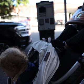 Child in Stroller on Sunny Street
