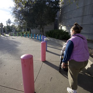 Parent and Child Exploring Colorful Bollard Installation