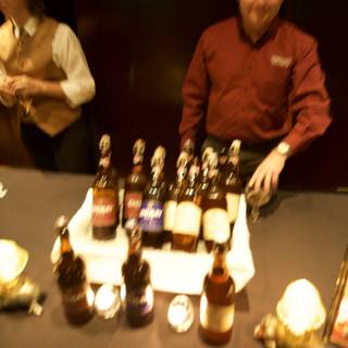 Man Behind Bar Table with Bottles of Alcohol