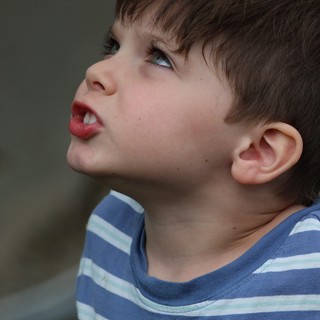 Young Child Looking Upward with Playful Expression