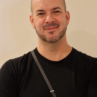 Professional Portrait of Smiling Bald Man in Black