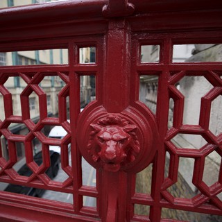 Ornate Lion Head Detail on Victorian Red Bridge Railing