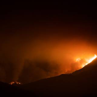 Station fire spreads through the night sky