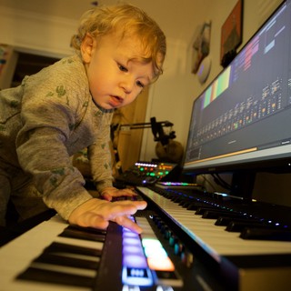 Young Child Exploring Music Production at Home Studio