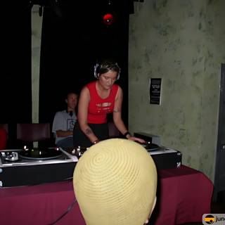 Red Shirt DJ Mixing Music on Turntable