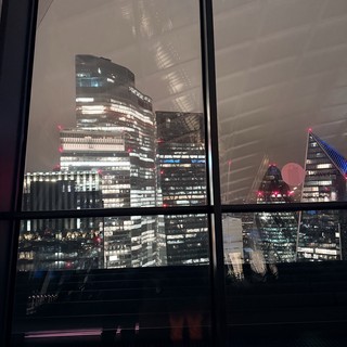 London Financial District Skyline at Night Through Window