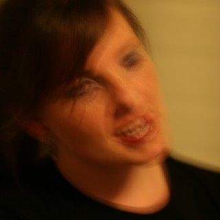 Motion Blur Portrait of Smiling Woman in Warmth