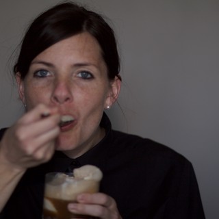 Woman Enjoying a Dessert Drink at Evening Gathering