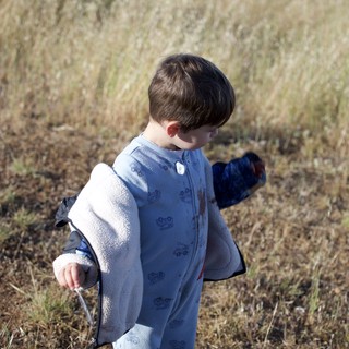 Young Explorer Walking Through Golden Meadow Grass
