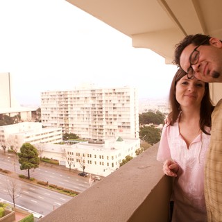 Couple Sharing a Tender Moment on City Balcony