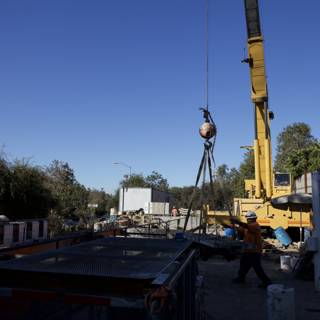 Construction Crane Lifting Large Object Over Site