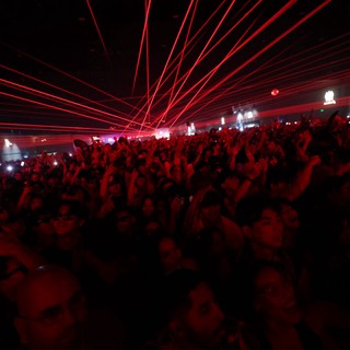 Red Laser Storm Over Massive Dance Music Crowd