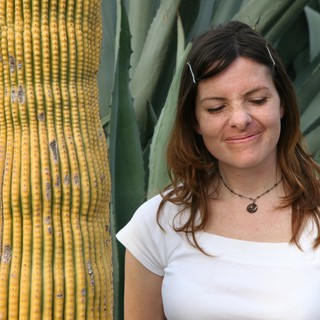Woman Smiling Beside Desert Cactus and Agave